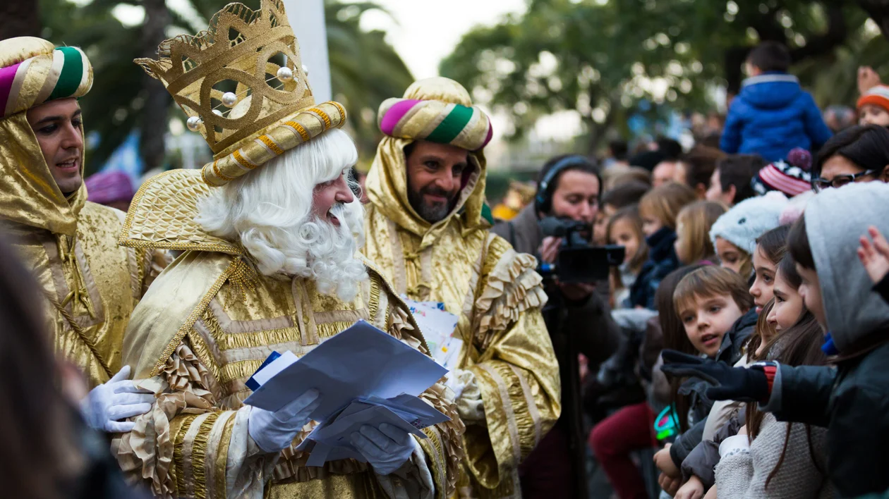 After opening the presents, enjoy a piece of Epiphany Cake and be careful, it has something special hidden inside: a small figure that brings good luck to the person lucky enough to find it in their slice. Picture: Three Magi collecting children’s letters at the port during the celebration. Barcelona, Spain. ©Iakov Filimonov/123RF