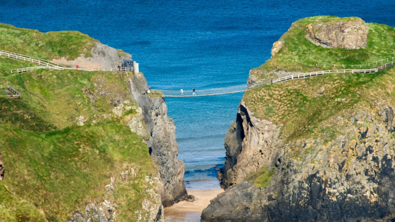 People crossing the Carrick-a-Rede Rope Bridge in County Antrim. © Tourism Ireland