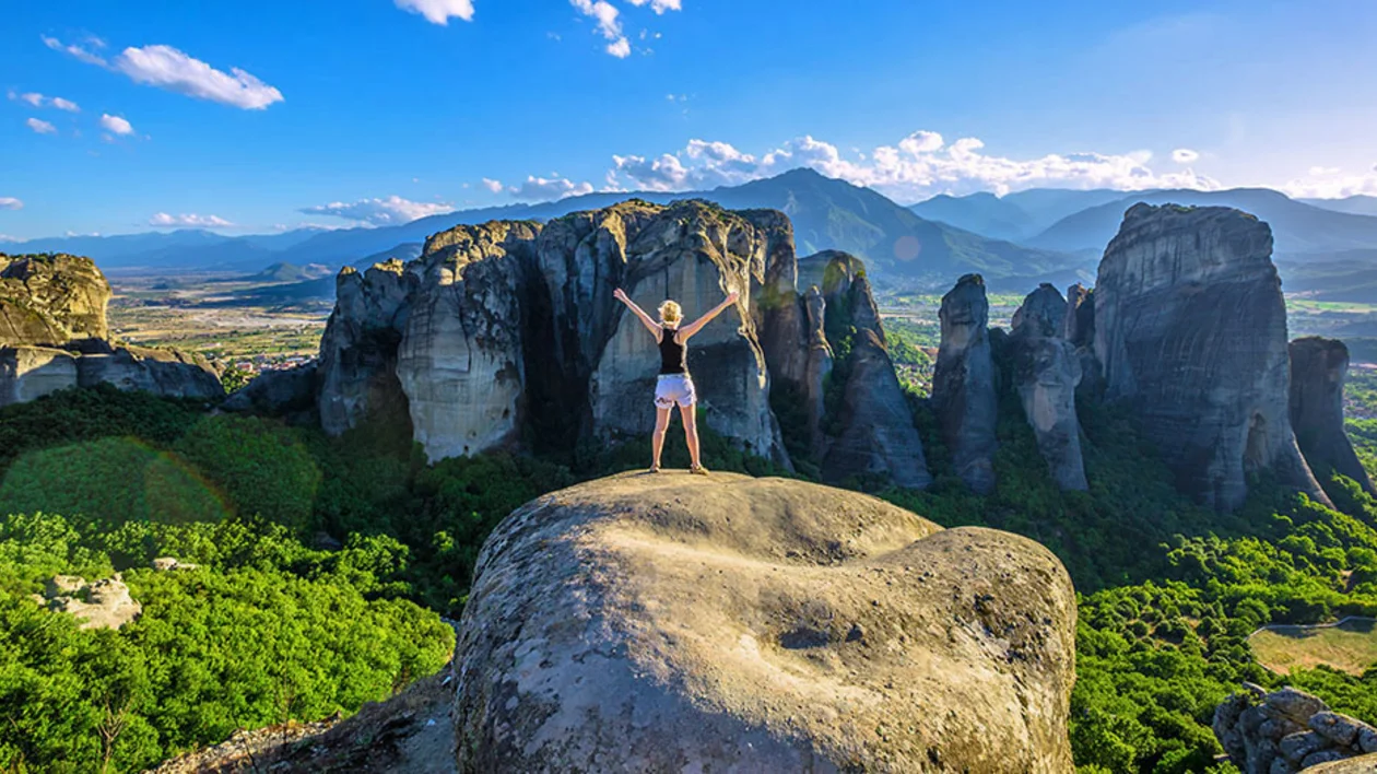 Woman traveler enjoying spectacular Meteora landscape in Thessaly, Greece. ©GNTO / Shutterstock