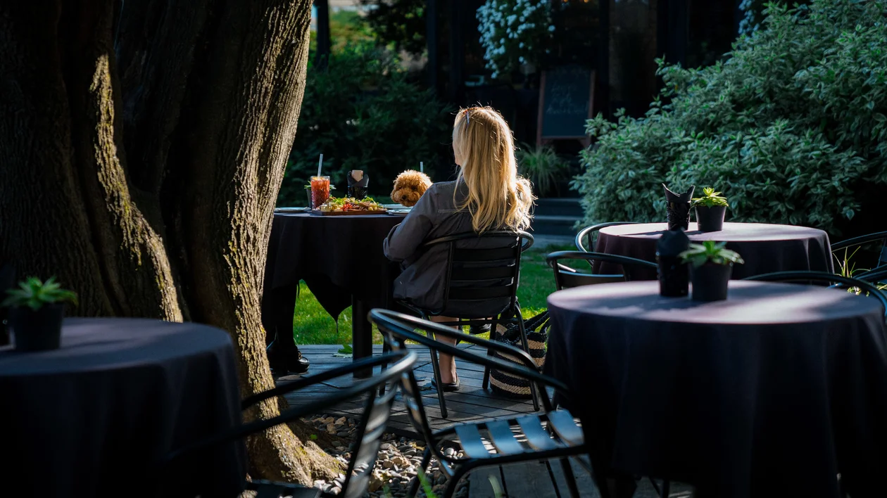 Two women sited at summer terraces in Riga.