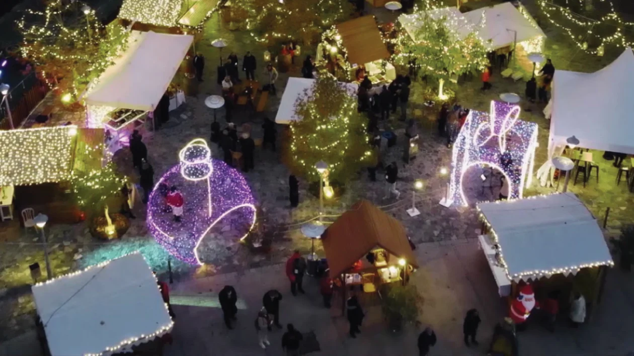 Aerial view of a outdoor Christmas market with illuminated trees and decoration.