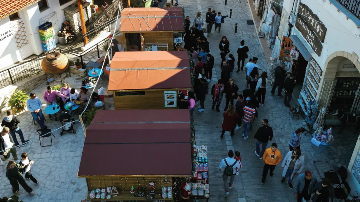 Aerial view of a bustling market street with people and stalls.