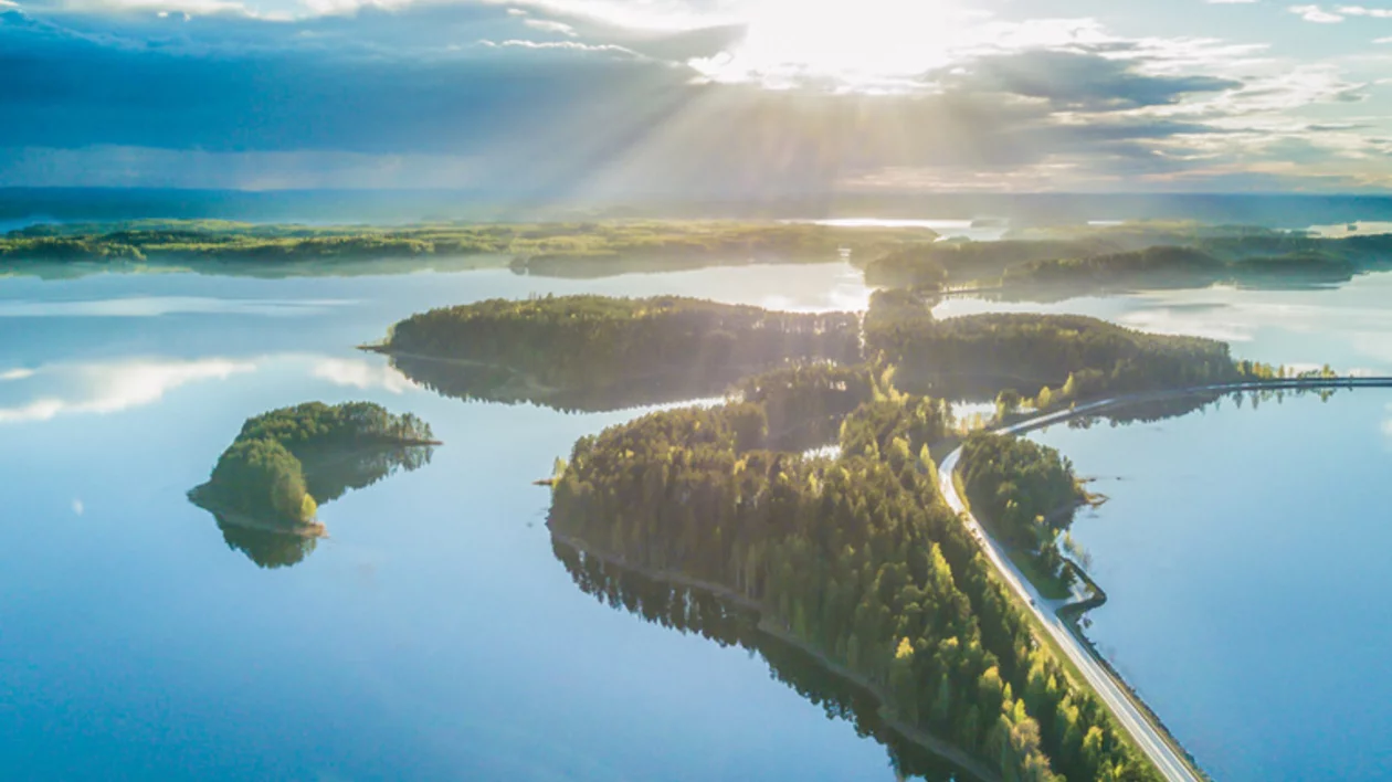 Aerial view of the scenic Punkaharju ridge and surrounding lakes in Finland under bright sunlight.