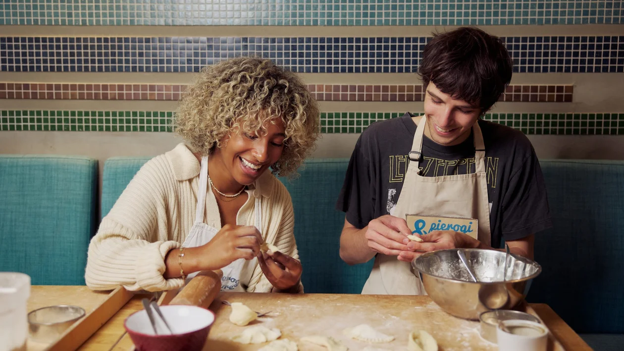 Traveler making pierogi during a cooking class in Warsaw, experiencing Polish traditions.
