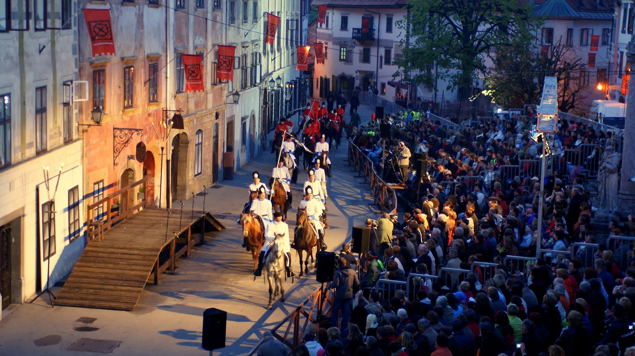 Open-air performance of the Škofja Loka Passion Play in Slovenia, with costumed actors on horseback and a large seated audience.