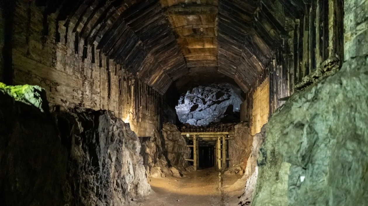 Underground tunnel of the Osówka complex with stone walls and reinforced concrete arches, part of the WWII Project Riese in Poland