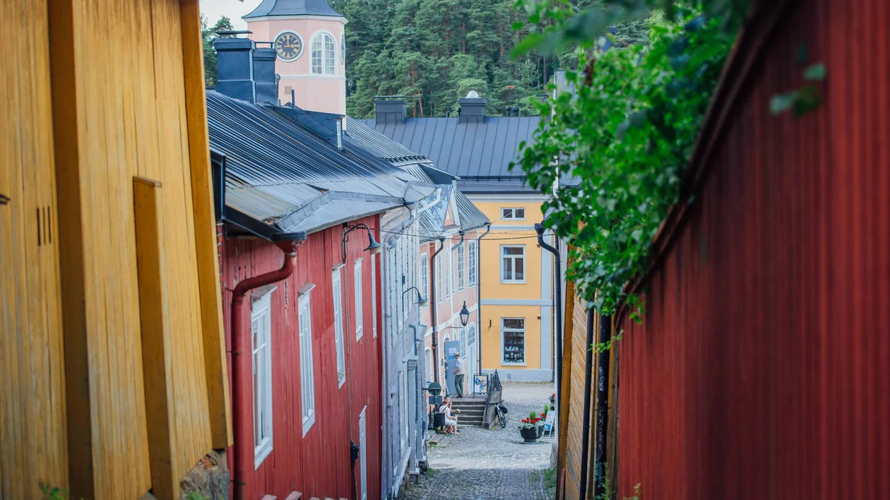 Colorful wooden houses lining a narrow street in Porvoo, Finland