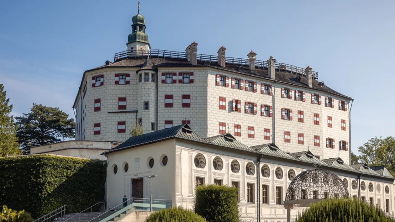 Ambras Castle in Innsbruck, a Renaissance palace overlooking the Alps with historic towers and gardens