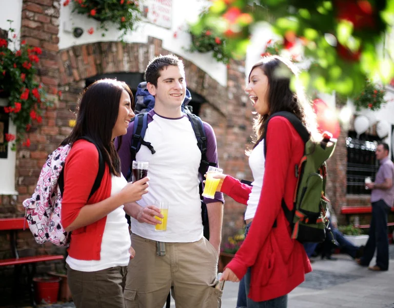 A group of young people have a discussion on a sunny day