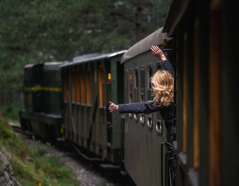 A girl is enjoying her trip in an ancient train