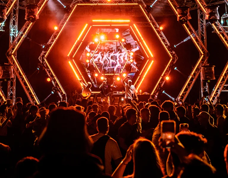 Night festival in Croatia with a band playing on a stage with red lights