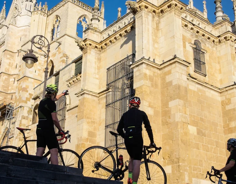 cyclist admiring an ancient church