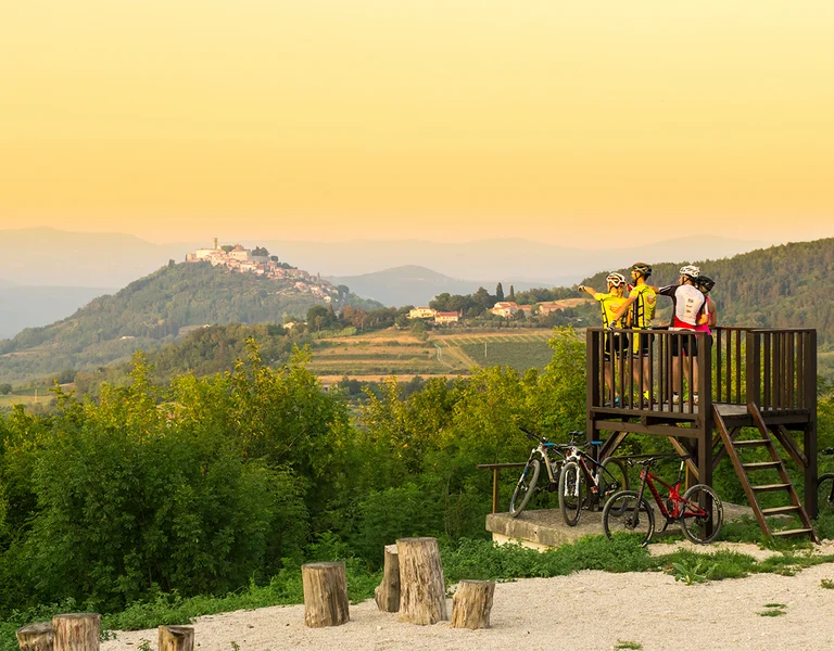 People admiring hills on their bike in Croatia.