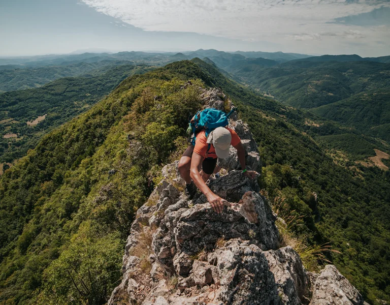 Serbia hiking trail and man climbing it.