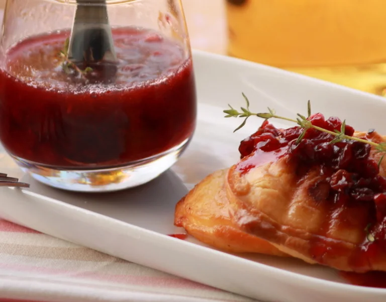 Grilled or baked smoked sheep’s cheese, typically served with a dollop of tart cranberry sauce, providing a perfect combination of salty and sweet.