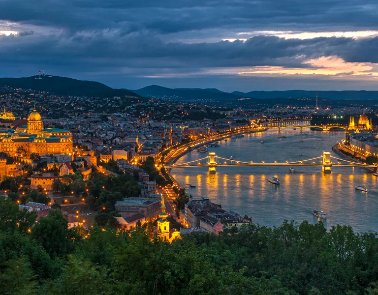Twilight view of Budapest with the Danube River and illuminated Chain Bridge.