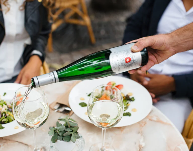 Outdoor dining in Maastricht, Netherlands, with fresh salad and white wine served at a charming terrace café.