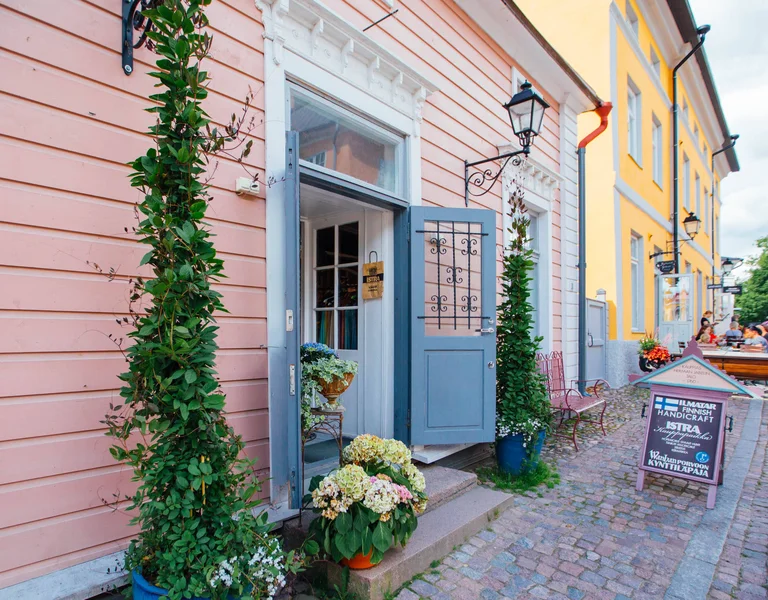 Colorful wooden houses along a cobblestone street in Porvoo, Finland