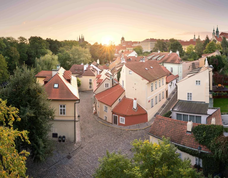 Sunset view over Nový Svět neighborhood with cobblestone streets and historic houses in Prague