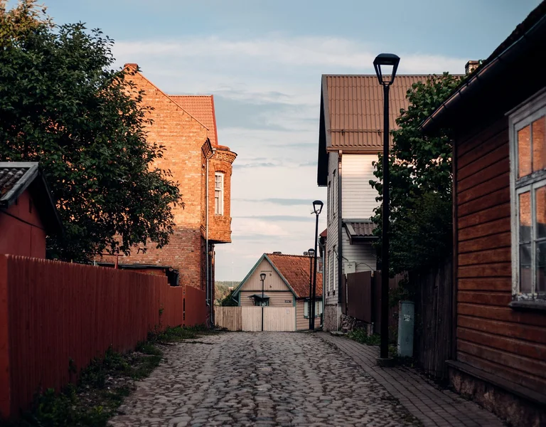 Cobblestone street lined with wooden houses in Viljandi old town, Estonia