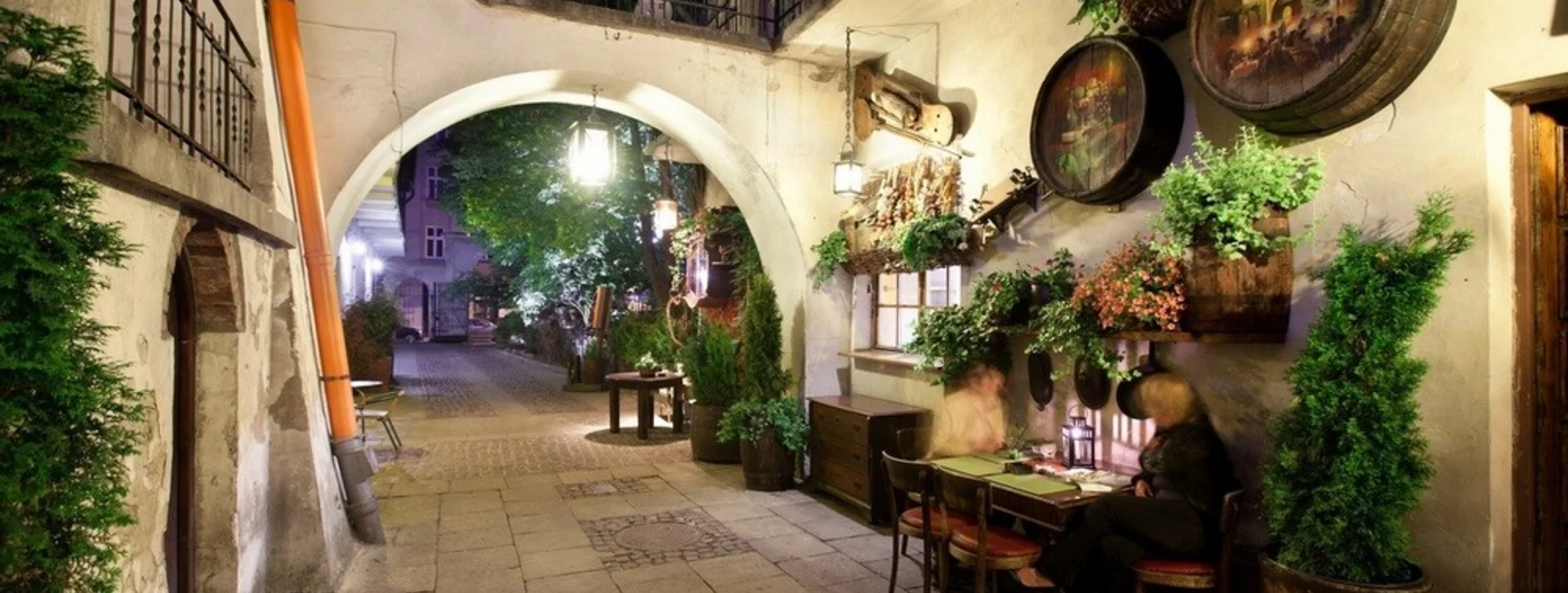 Evening scene of a couple dining outside a well-known restaurant in the Kazimierz district of Krakow.