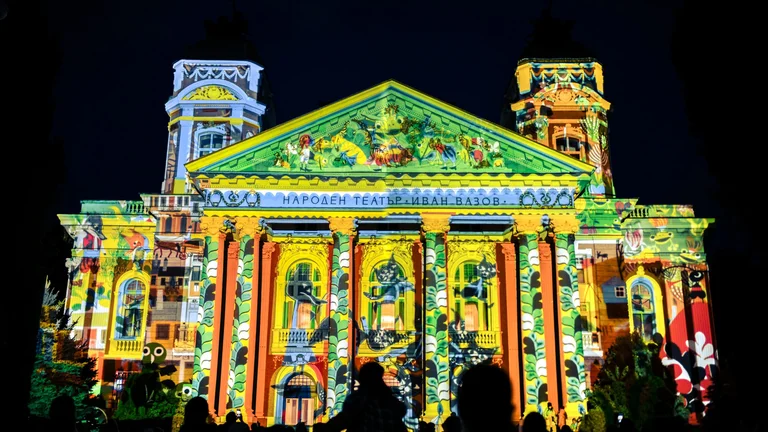 Night view of Sofia’s city center illuminated by colorful light installations and 3D‑mapping projections during the LUNAR Festival of Lights.