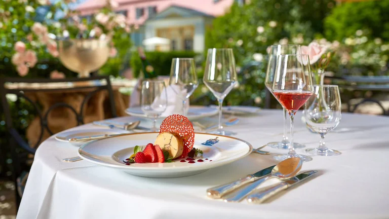 Elegant dessert and rosé on a garden terrace table