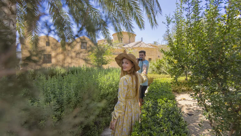 Couple walking through garden near Panayia Chrysaliniotissa in Nicosia