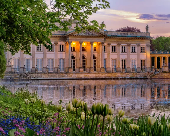 Pałac na Wyspie - Łazienki Królewskie. A Neoclassicist palace in Warsaw with a lot of flowers in spring.