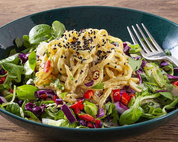 Visit the first raw food and plant-based canteen in Bratislava for a perfect combination of greens, pasta, veggies, and sesame seeds.