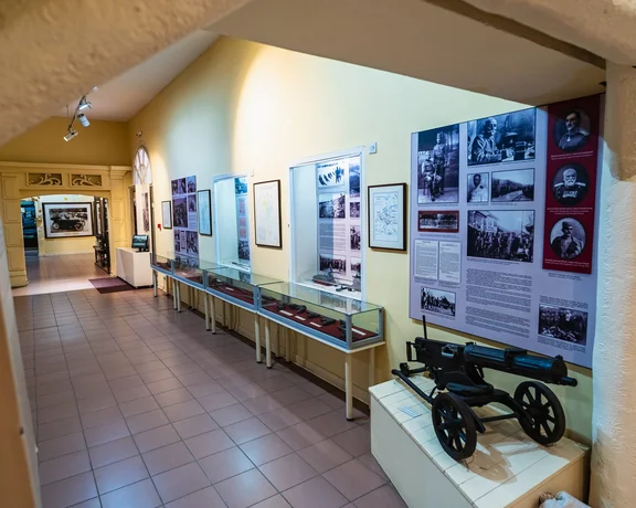 Exhibition of a in Valjevo, Serbia, with historical artifacts arranged along well-lit gallery walls.