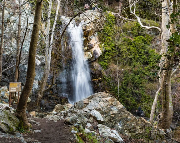 Forest waterfall cascading over rocks along a hiking trail in the Troodos Mountains