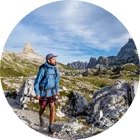 Man hiking in the Dolomites with all the mountains around.